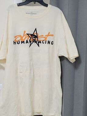 Human Racing Graphic Tee in Cream with Orange & Black Logo